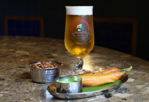 Deep fried battered jumbo chilli stuffed with spiced potato and served with beer and nuts