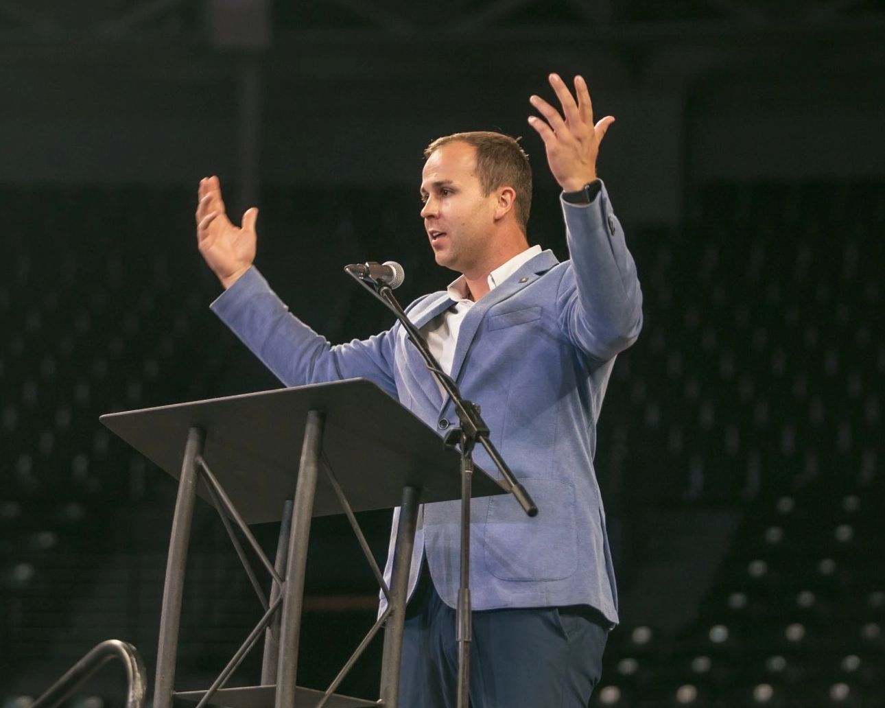 Conner Hampton is giving a public speech on simplification at an event.