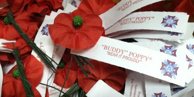 Red remembrance poppies with labels.