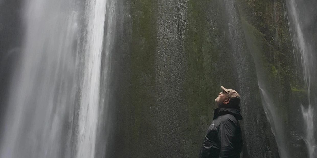 Person admiring a waterfall.