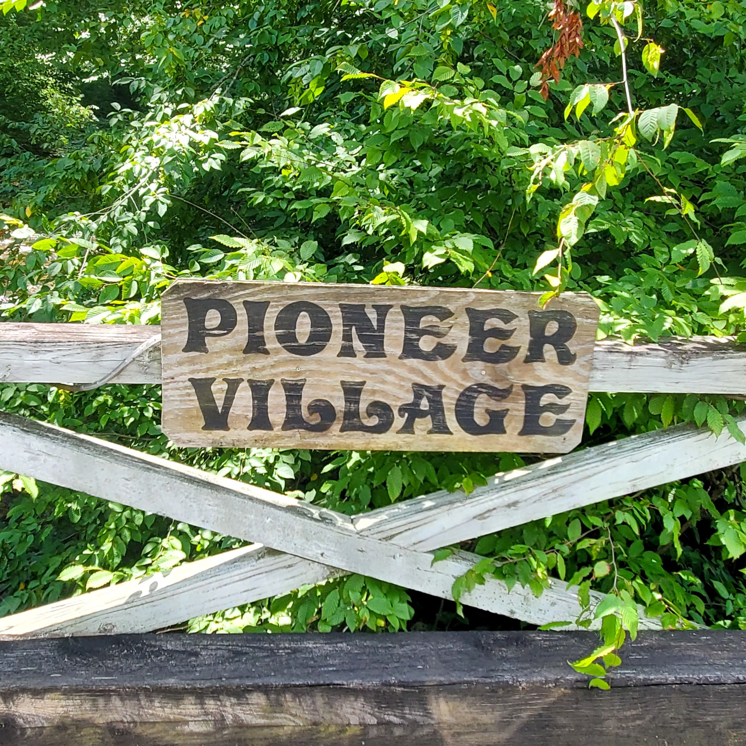 Pioneer Village sign on the bridge