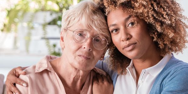 Two women embracing, showing support and connection.