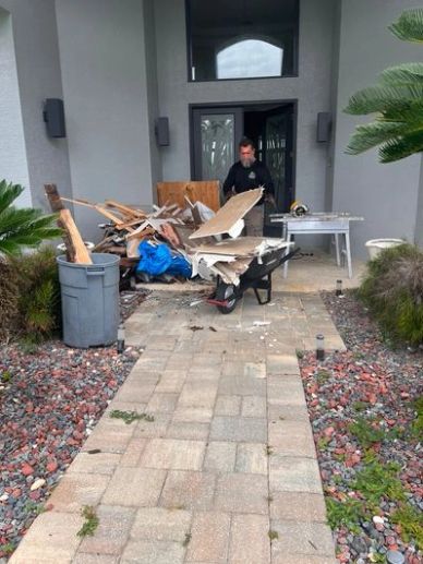 Junk Zilla team member removing renovation debris in Port Orange, FL