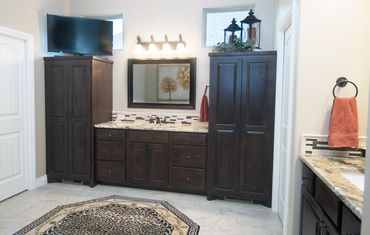 Natural wood bathroom with decorative objects above the cabinetry.