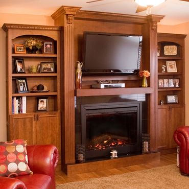 Fireplace with built-in bookshelves and mounted TV.