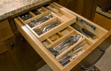 Kitchen island with convenient pull-out trash and recycling bins.