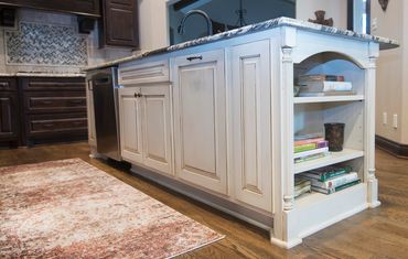 Modern kitchen island featuring a dual bin pull-out waste system.