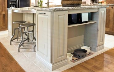 Pull-out trash can discreetly hidden inside a kitchen island.