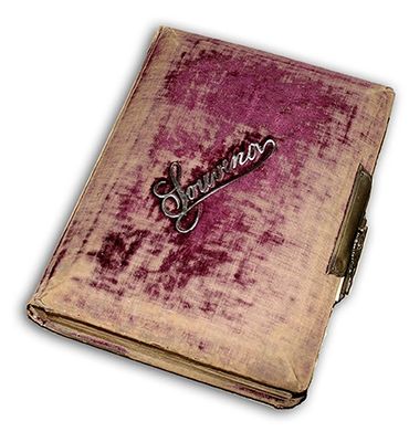 Vintage journal with a worn purple cover and a metal clasp.
