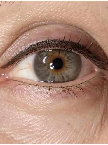 Close-up of a human eye with natural skin texture.
