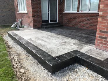 A concrete patio featuring a sleek, smooth finish means durable and low-maintenance outdoor living.