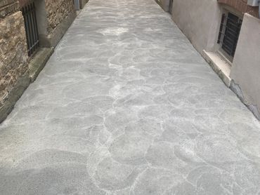 Concrete driveway, designed with a clean, modern aesthetic and reinforced for enhanced durability.