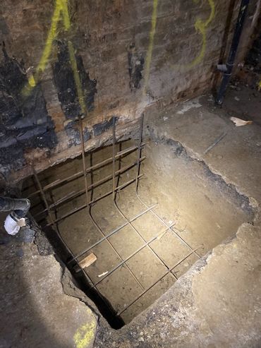 Basement lowering project with underpinning for increased ceiling height. strengthen home foundation