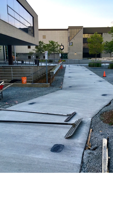 A durable, smooth concrete walkway, designed for high foot traffic and long-lasting performance.