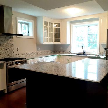 Open kitchen with wood cabinetry, sleek countertops, and lighting for functional, inviting space