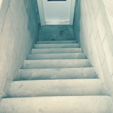 Toronto home walkout construction with concrete stairs and retaining wall.