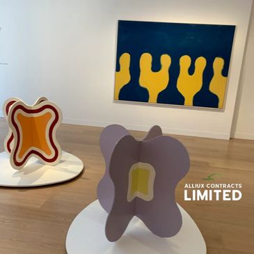 Abstract sculptures and painting in a modern art gallery.