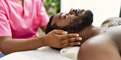 a man getting a facial massage from a lady
