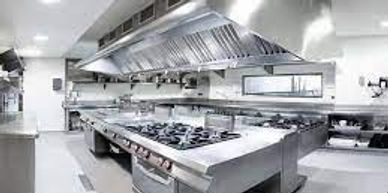 A clean, modern commercial kitchen with stainless steel appliances.