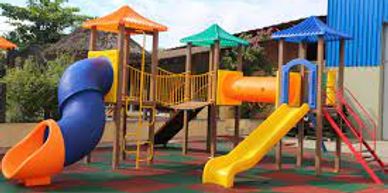 Colorful playground with slides and climbing structures under a clear sky.