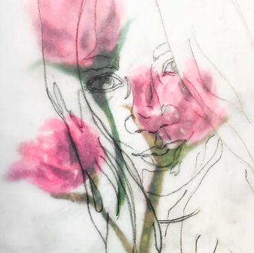 A delicate sketch of a woman's face blended with soft pink flowers.