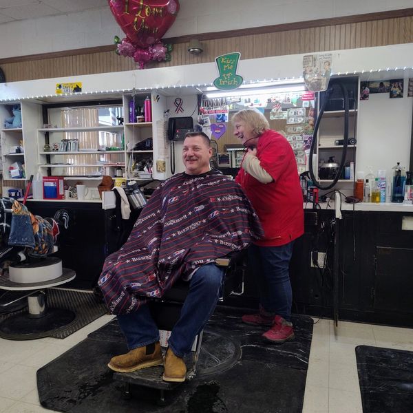 Man getting a haircut in a barbershop.