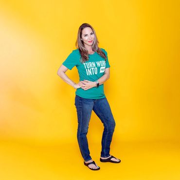 A woman wearing a blue-green shirt