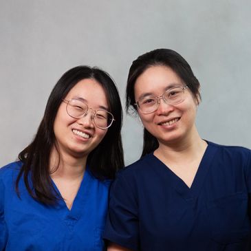 Image of assistants, lab technicians and staff wearing professional attire and smiling confidently.