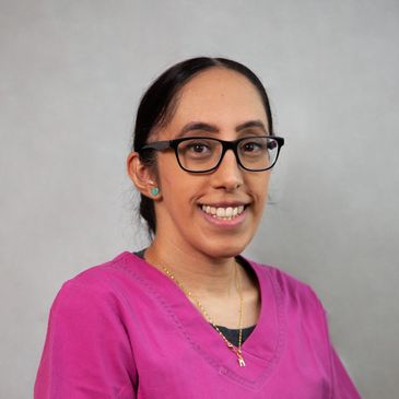 Profile image of Manj Sihota, RDH, wearing professional pink attire and smiling confidently.