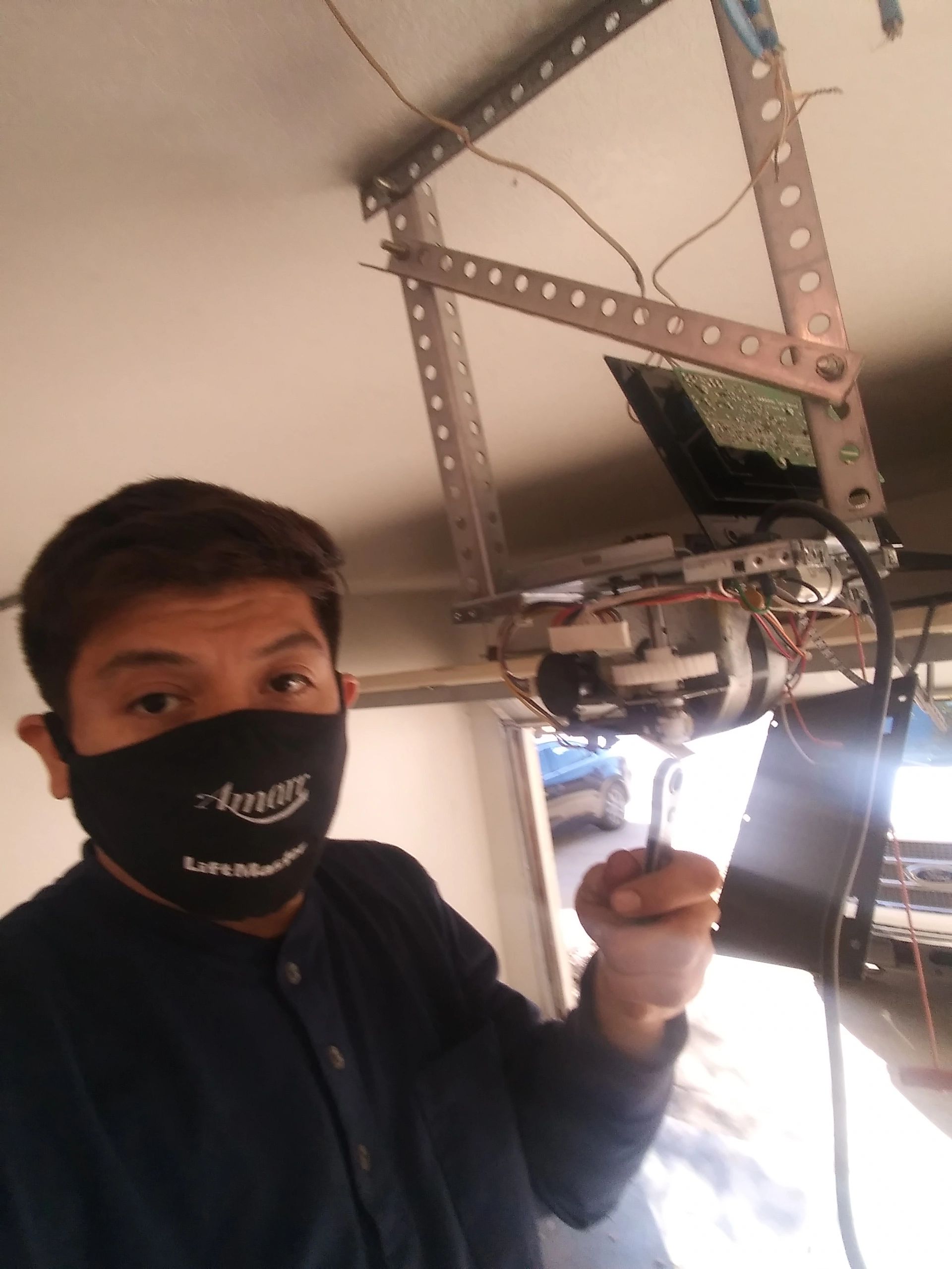 garage door guy at work for garage door repair systems.