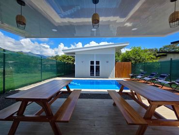 Outdoor pool area with lounge seating at Life’s a Beach Uvita in Uvita, Costa Rica