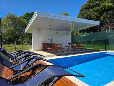 Outdoor view showing the pool and loungers at Life’s a Beach Uvita