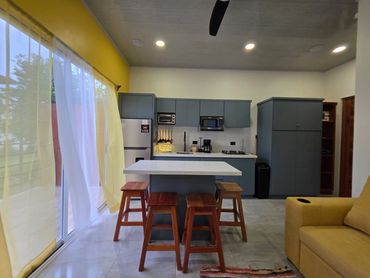 Kitchen interior with refrigerator, oven, and dining setup