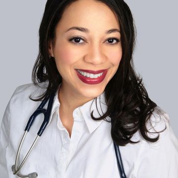 A photo of Dr. Mikel Hoffman, wearing a white button down and a stethoscope around her shoulders.