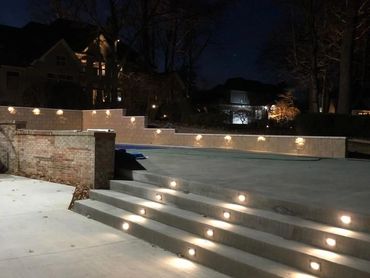 Pool wall and concrete deck lighting—enhancing safety, ambiance, and nighttime appeal.