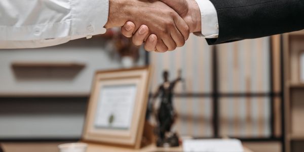 Licensed lawyer shaking hands with client