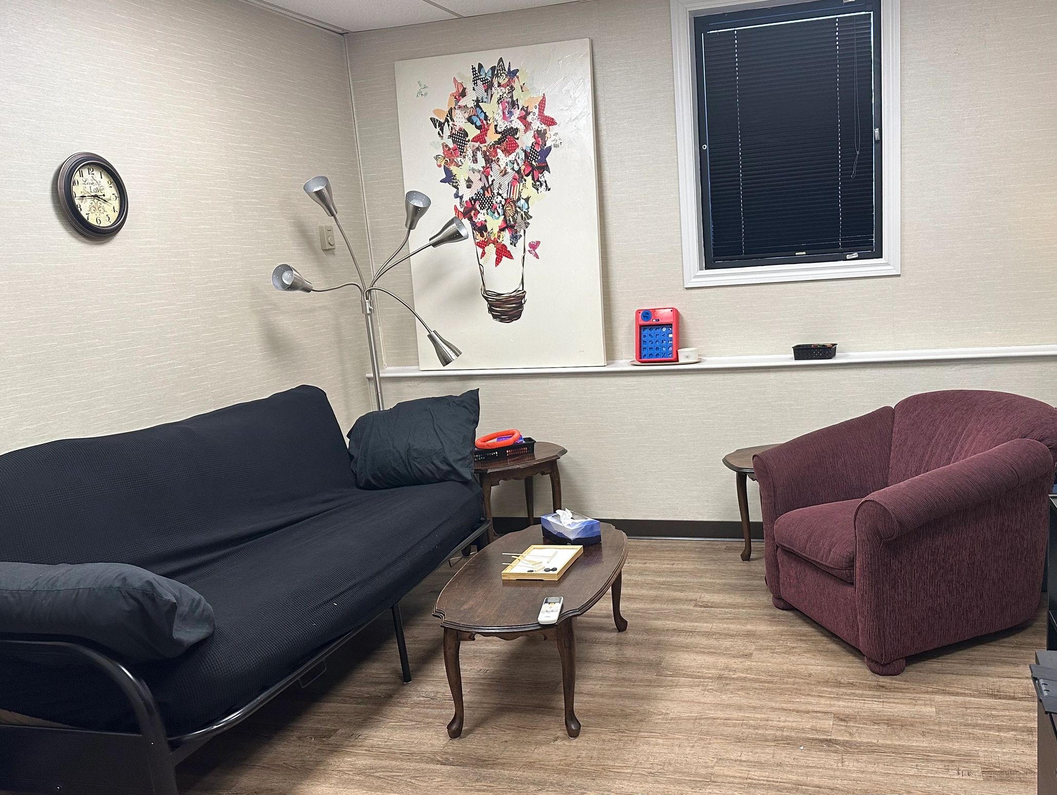 The therapy room, with a couch on the left and chair on the right.