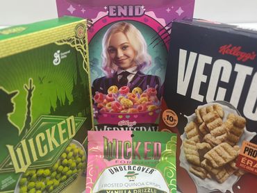Four cereal boxes including Wicked, Enid, and Kellogg's Vector.