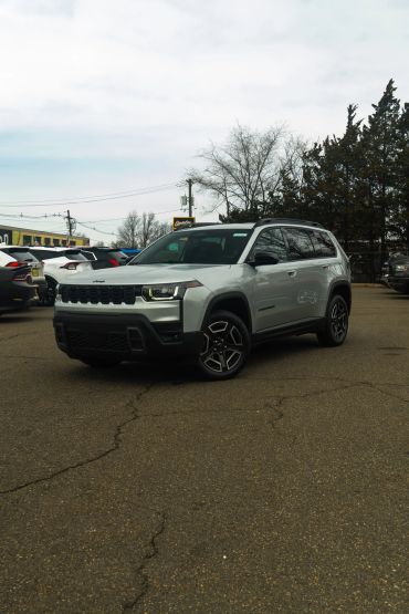 A silver Jeep Cherokee parked outdoors.