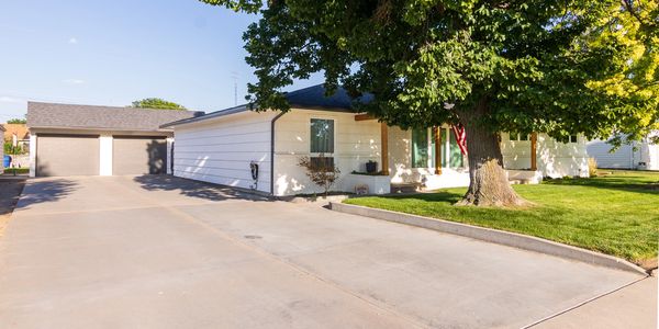 Single-story house with large driveway and garage.