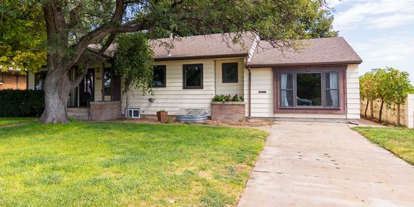 Single-story house with lawn and driveway.
