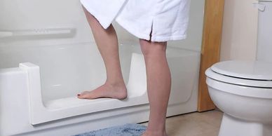 Step in shower from bathtub cut out installation to modify bathtub for seniors.