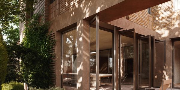 Modern brick patio with minimalist chairs and greenery.