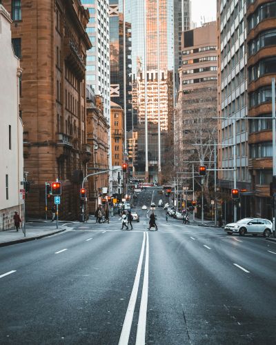 Sydney CBD streetscape with historic sandstone buildings and modern skyscrapers, representing Leone