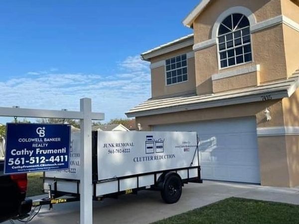 Trailer parked in driveway of house for sale