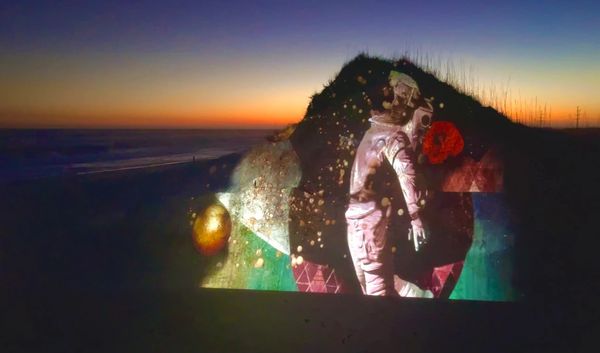 video mapping of astronaut  onto a dune by Artist Robin Vuchnich, projection mapping North Carolina