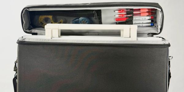 A black zippered organizer bag with pens and earbuds.