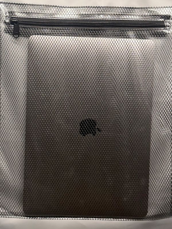 Apple laptop in a mesh sleeve.