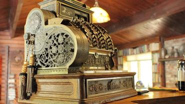 Ornate vintage National cash register on a wooden counter.