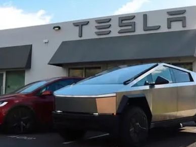 Tesla Cybertruck and Model Y parked outside a Tesla store.